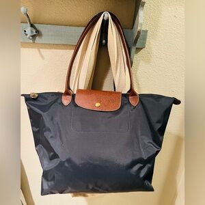 Longchamp Le Pliage Tote in navy blue.